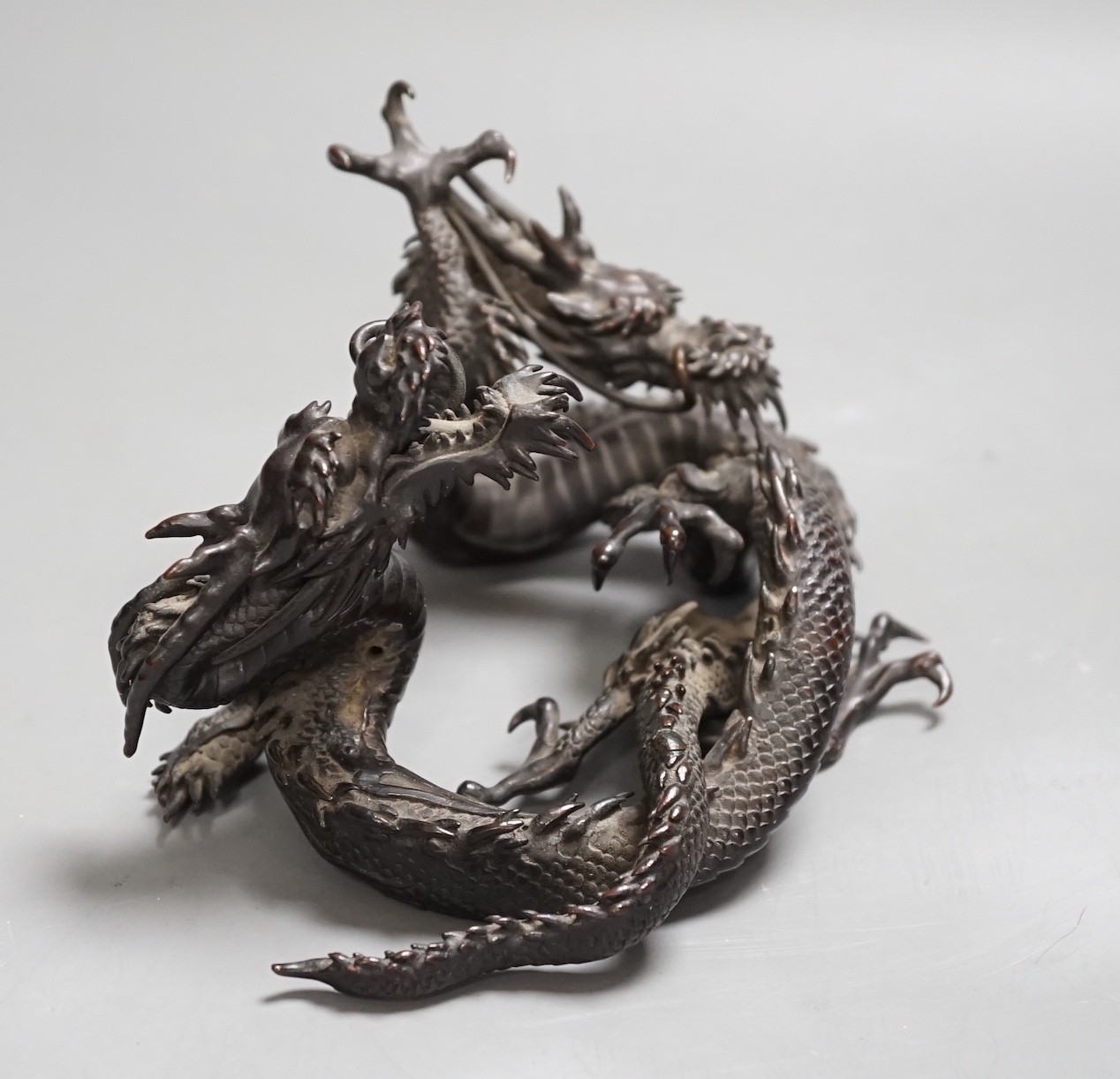A Japanese bronze group of two entwined dragons, Meiji period, 17cms wide